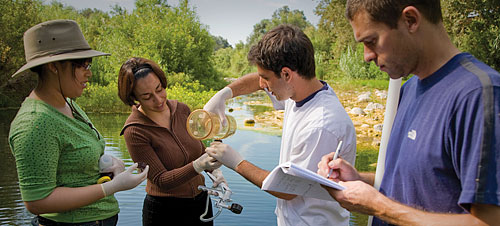Students Sarah Muliadi, Lyra Porcasi and Alex Sherbetjian filter sediment and particles out of water collected from the Ventura River while chemistry professor Grady Hanrahan records measurements.