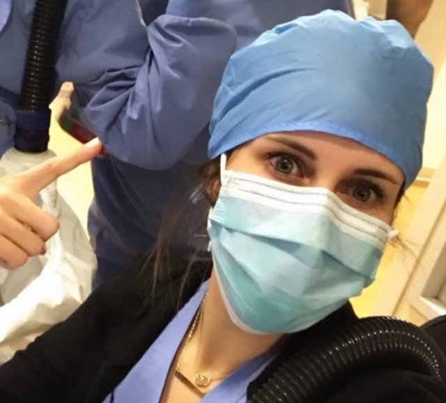 Nurse pointing to a scrub cap
